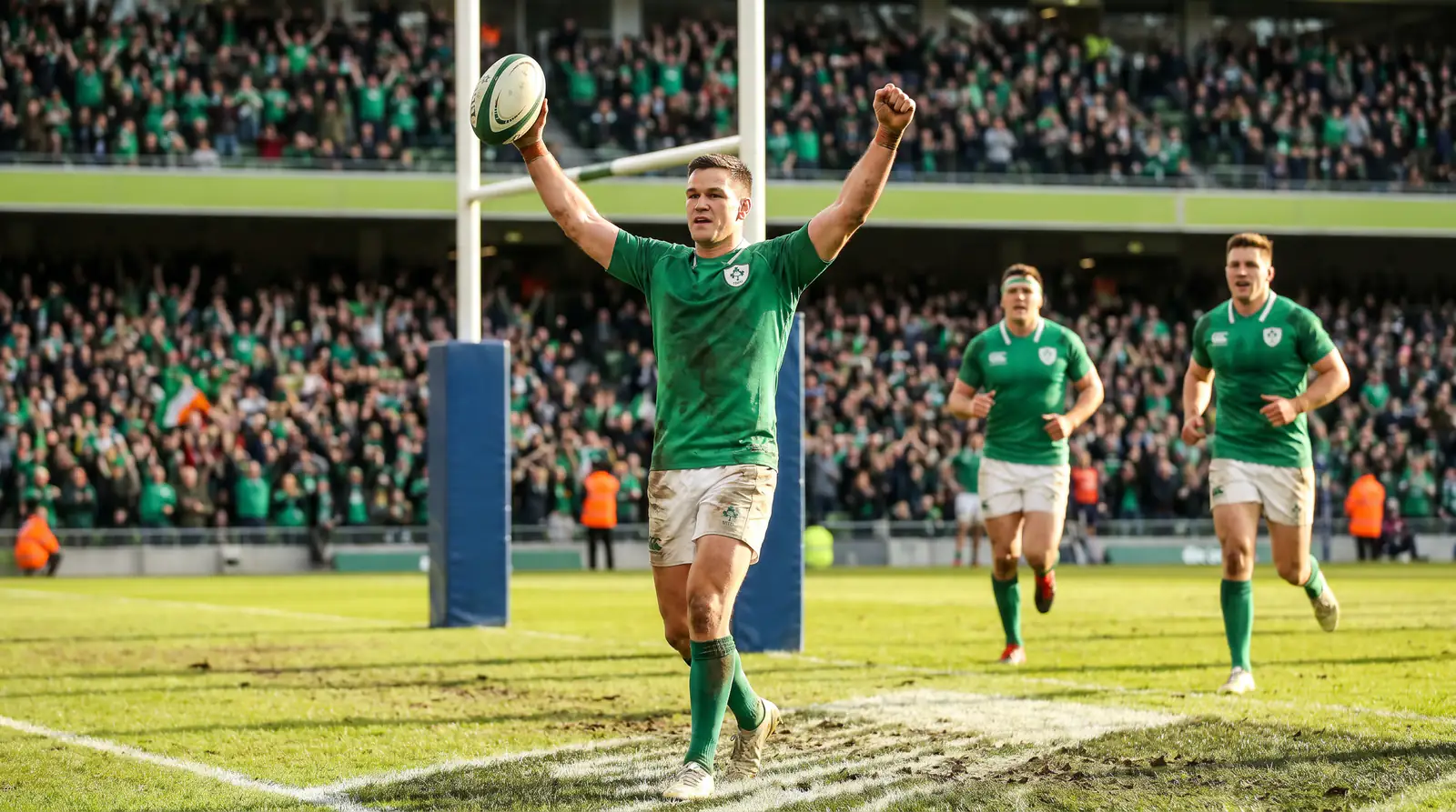 Rugby union back celebrating an anytime try with arms raised after grounding the ball in the in-goal area