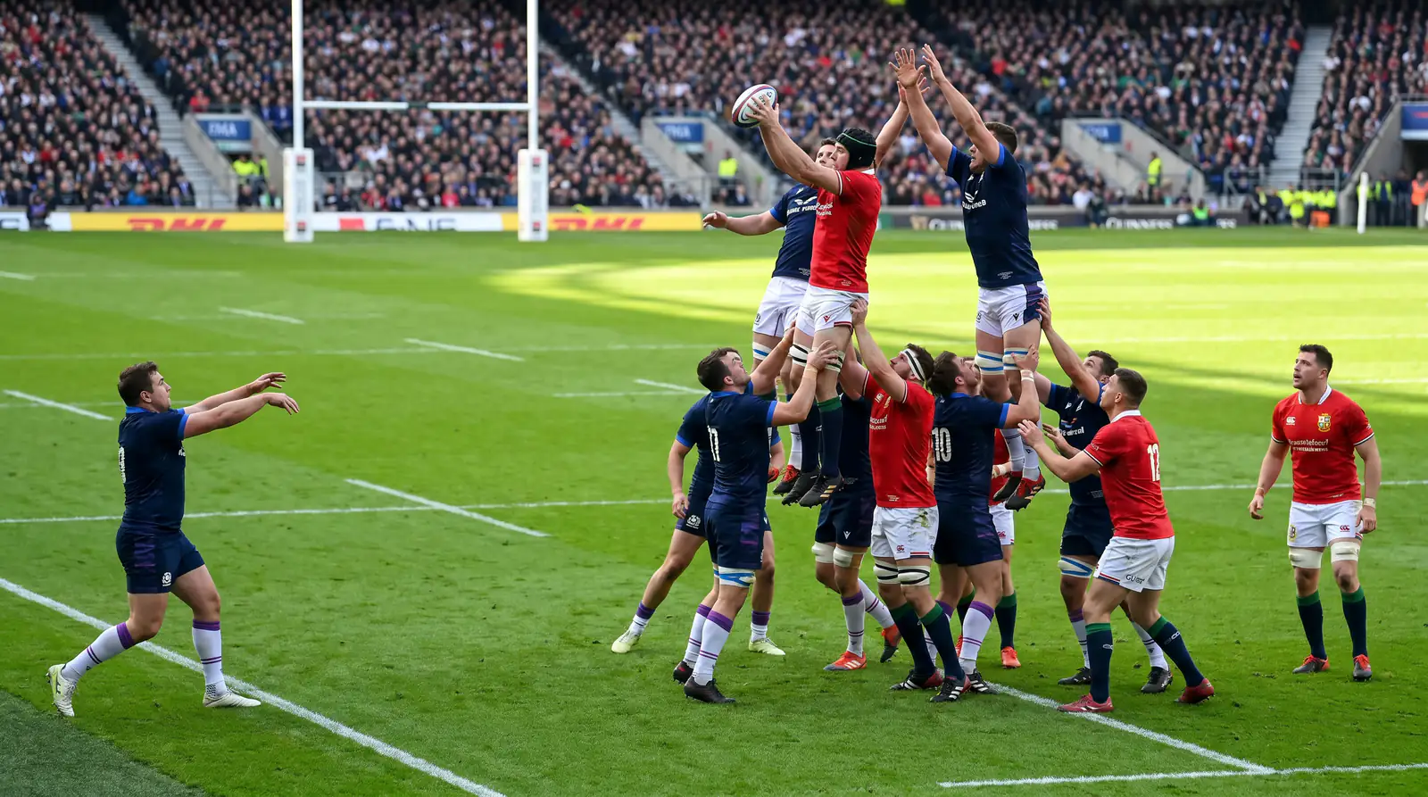 Rugby union pool stage international match action with line-out throw between two international packs