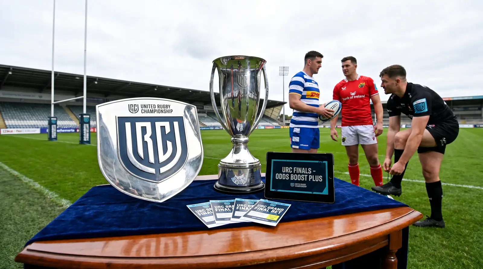 URC shield and championship trophy on display table at venue